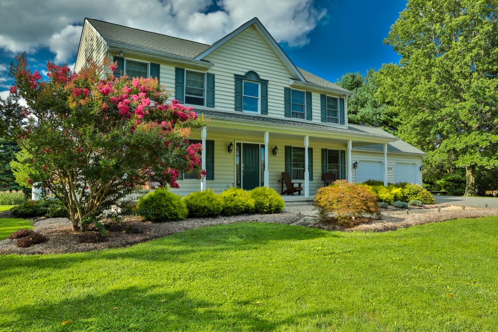 Residential front yard landscaping with garden beds and manicured lawn on a Hamilton area home.